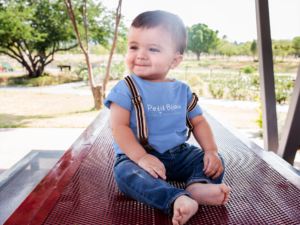 happy-baby-boy-wearing-a-round-neck-tshirt-mockup-and-suspenders-a16104