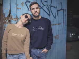 happy-couple-wearing-different-crewneck-sweatshirts-mockup-while-standing-against-a-blue-door-a15804
