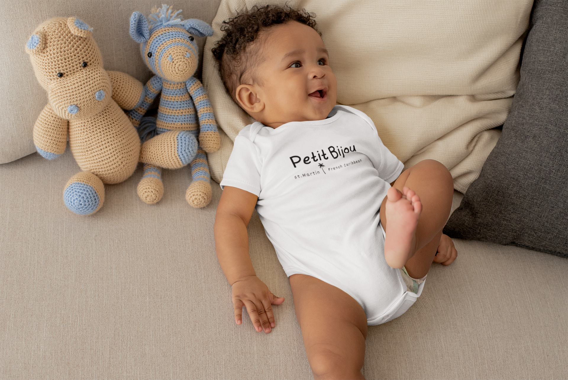 onesie-mockup-of-a-cute-baby-boy-lying-in-bed-with-stuffed-animals-25121