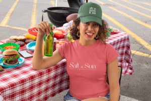 t-shirt-mockup-of-a-curly-haired-woman-with-a-trucker-hat-at-a-tailgate-party-29898