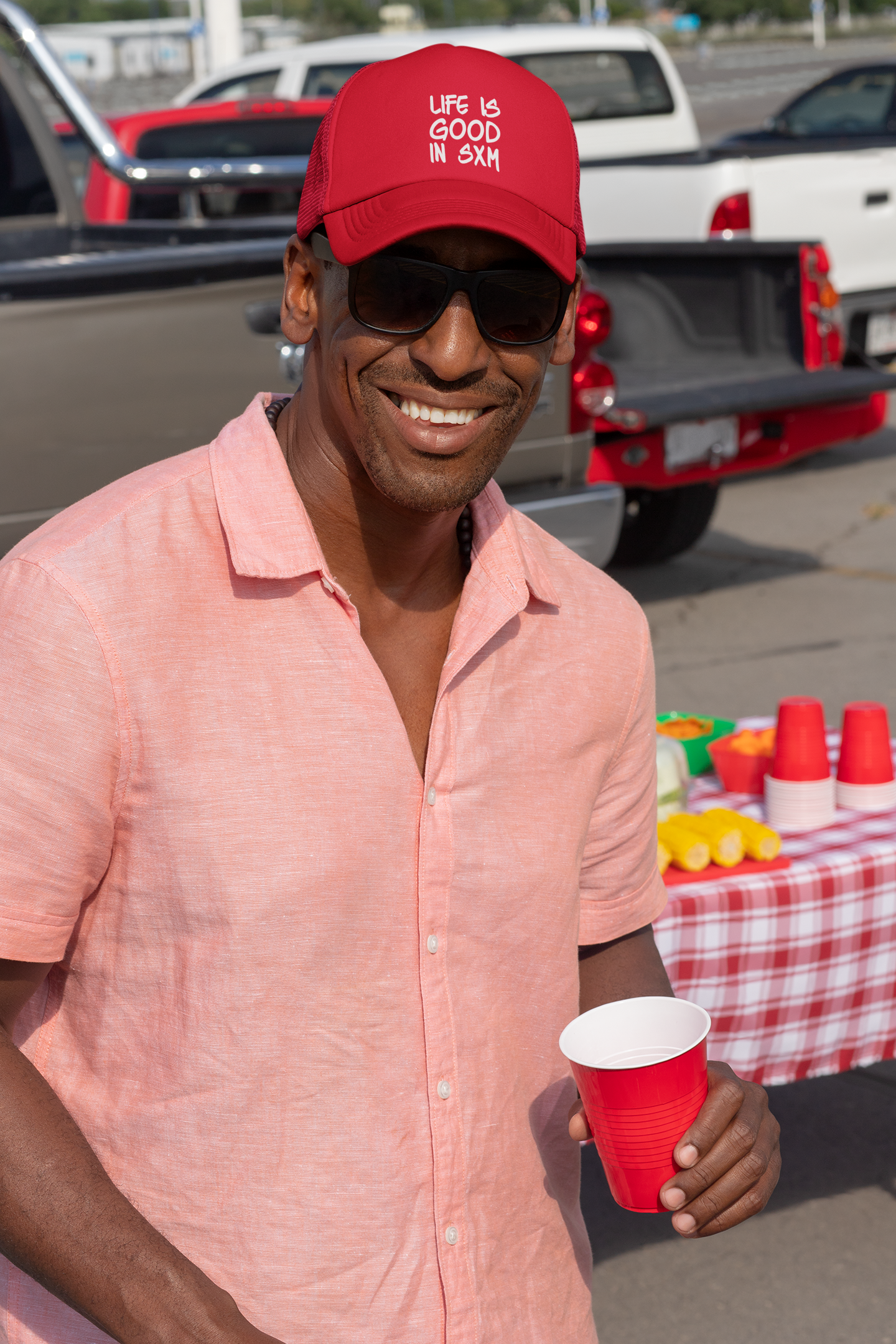 trucker-hat-mockup-of-a-man-tailgating-at-a-parking-lot-29877